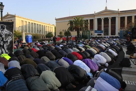 Muslim immigrants pray during Eid al-Adha celebrations in front of Athens university