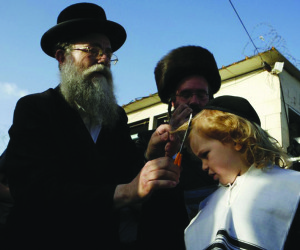 Ultra-Orthodox Jewish boy gets his first haircut during celebrations for Lag Ba-Omer on Meron mountain