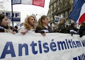 People march through Paris to protest against racism and anti-Semitism following the torture and kil..