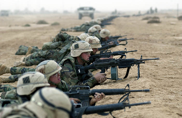 Armed with 5.56mm M16A2 rifles and a 5.56mm M249 Squad Automatic Weapon (SAW), US Army (USA) Soldiers assigned to the 3rd Infantry Division take up defensive firing positions during an enemy approach on their position at objective RAMA, in Southern Iraq, during Operation IRAQI FREEDOM.
