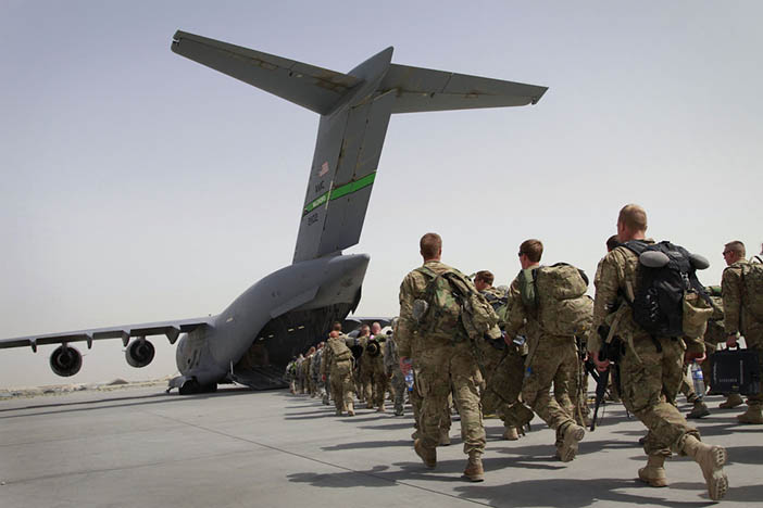 U.S. soldiers walk into a U.S. military plane, as they leave Afghanistan, at the U.S. base in Bagram, north of Kabul, Afghanistan on Thursday, July 14, 2011.