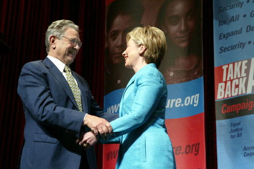 WASHINGTON - JUNE 3: Philanthropist George Soros (L) greets U.S. Senator Hillary Clinton (D-NY) after she introduced him at the Take Back America Conference June 3, 2004 in Washington, DC. The conference aims to unite progressive issue groups as well as train for organizing campaigns in 2004 and beyond. (Photo by Matthew Cavanaugh/Getty Images)