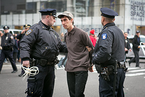 A protester is arrested by the police after refusing to go back to the side walk in New York City on Dec. 1, 2014. Around 150 High School students marched around the city in protest of the recent police shootings of unarmed black males. (Benjamin Chasteen/Epoch Times)