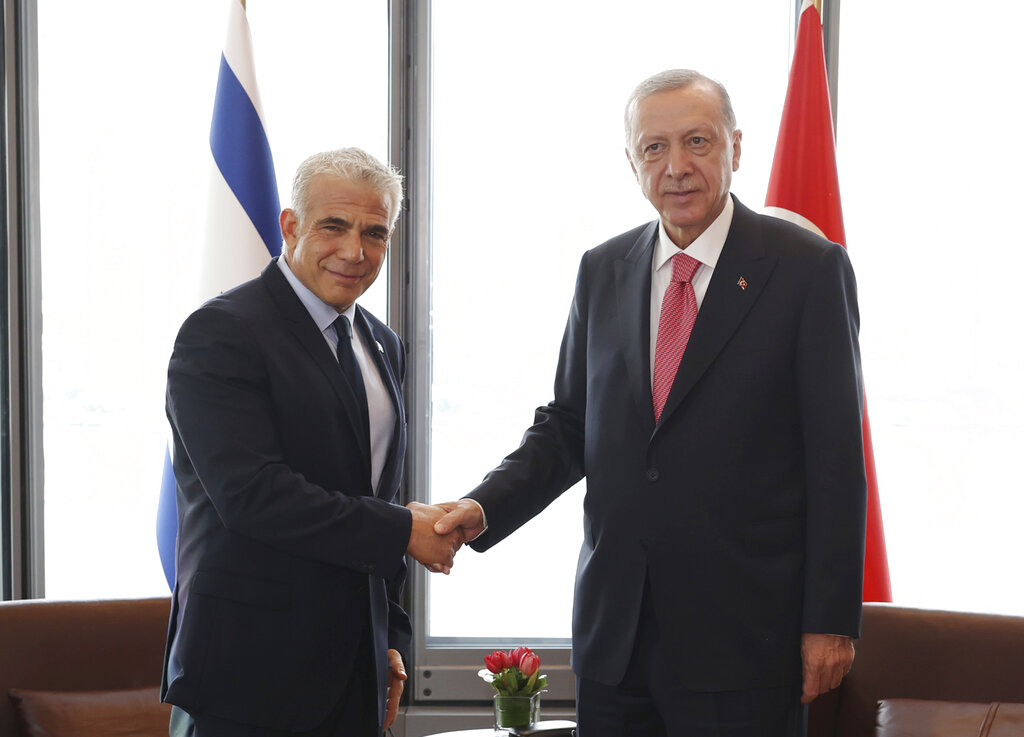 In this photo provided by the Turkish Presidency, Turkey's President Recep Tayyip Erdogan, right, shakes hands with Israeli Prime Minister Yair Lapid during their meeting on the sidelines of the United Nations General Assembly in New York, US, Tuesday, Sept. 20, 2022. (Turkish Presidency via AP)