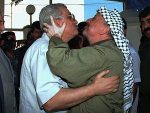 ** FILE ** Then PLO chief Yasser Arafat, right embraces Mahmoud Abbas upon his arrival at Arafat's office in Gaza City in this July 13, 1995 file photo. Arafat  picked  Abbas, 67, to fill the new post of prime minister of the Palestinian Authority, according to the speaker of the Palestinian parliament. (AP Photo)