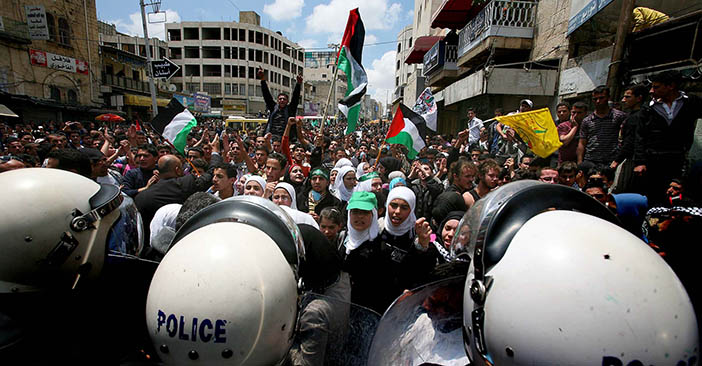 Palestinian police block the street as p