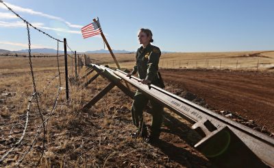 SONOITA, AZ - FEBRUARY 26:  A U.S. Border Patrol agent looks into Mexico from the U.S.-Mexico border on February 26, 2013 near Sonoita, Arizona. The Federal government has increased the Border Patrol presence in Arizona, from some 1,300 agents in the year 2000 ro 4,400 in 2012. The apprehension of undocumented immigrants crossing into the U.S. from Mexico has declined during that time from 600,016 in 2000 to 123,000 in 2012.  (Photo by John Moore/Getty Images)