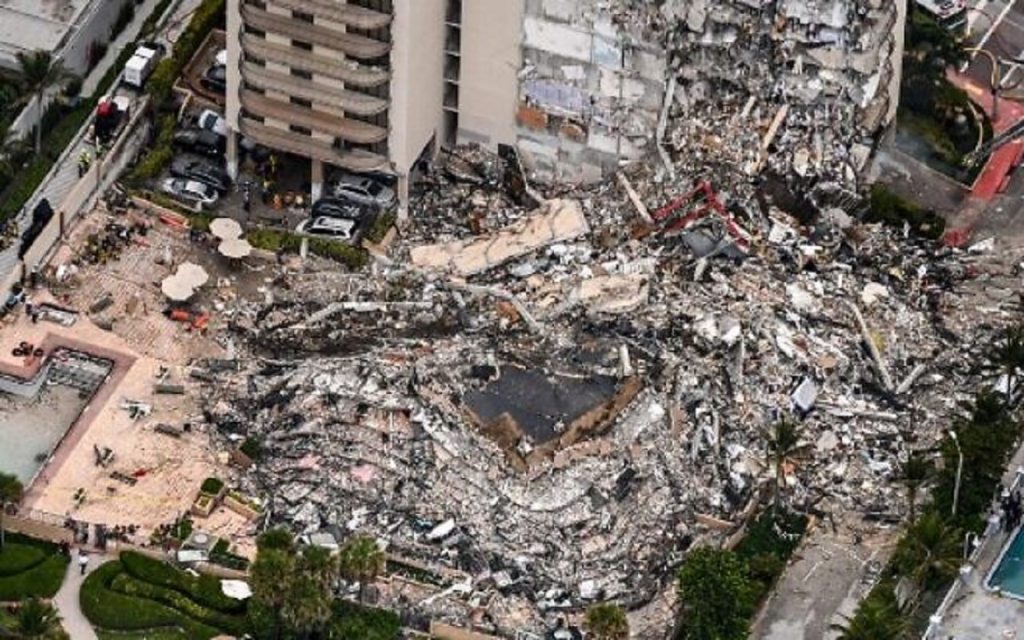 This aerial view, shows search and rescue personnel working on site after the partial collapse of the Champlain Towers South in Surfside, north of Miami Beach, on June 24, 2021. - The multi-story apartment block in Florida partially collapsed early June 24, sparking a major emergency response. Surfside Mayor Charles Burkett told NBC’s Today show: “My police chief has told me that we transported two people to the hospital this morning at least and one has died. We treated ten people on the site.” (Photo by CHANDAN KHANNA / AFP)