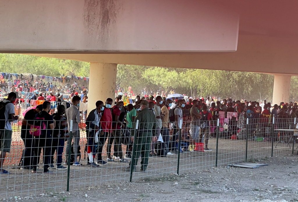 Migrants stand by the International Bridge between Mexico and the U.S., in Del Rio, Texas, U.S., September 16, 2021, in this picture obtained from social media. Picture taken September 16, 2021. OFFICE OF U.S. CONGRESSMAN TONY GONZALES (TX-23)/via REUTERS THIS IMAGE HAS BEEN SUPPLIED BY A THIRD PARTY. MANDATORY CREDIT. NO RESALES. NO ARCHIVES.