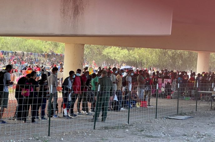 Migrants stand by the International Bridge between Mexico and the U.S., in Del Rio, Texas, U.S., September 16, 2021, in this picture obtained from social media. Picture taken September 16, 2021. OFFICE OF U.S. CONGRESSMAN TONY GONZALES (TX-23)/via REUTERS THIS IMAGE HAS BEEN SUPPLIED BY A THIRD PARTY. MANDATORY CREDIT. NO RESALES. NO ARCHIVES.