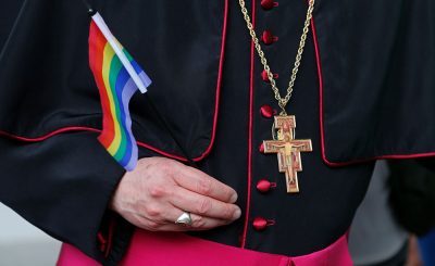 Rev. Roger LaRade, of the Eucharistic Catholic Church in Canada, carries a gay pride flag before giving blessings to couples from the LGBT community in Havana, Cuba, Saturday, May 9, 2015. The blessing ceremony on an island where gay marriage remains illegal was part of official ceremonies leading up to the Global Day against Homophobia on May 17.  (AP Photo/Desmond Boylan)
